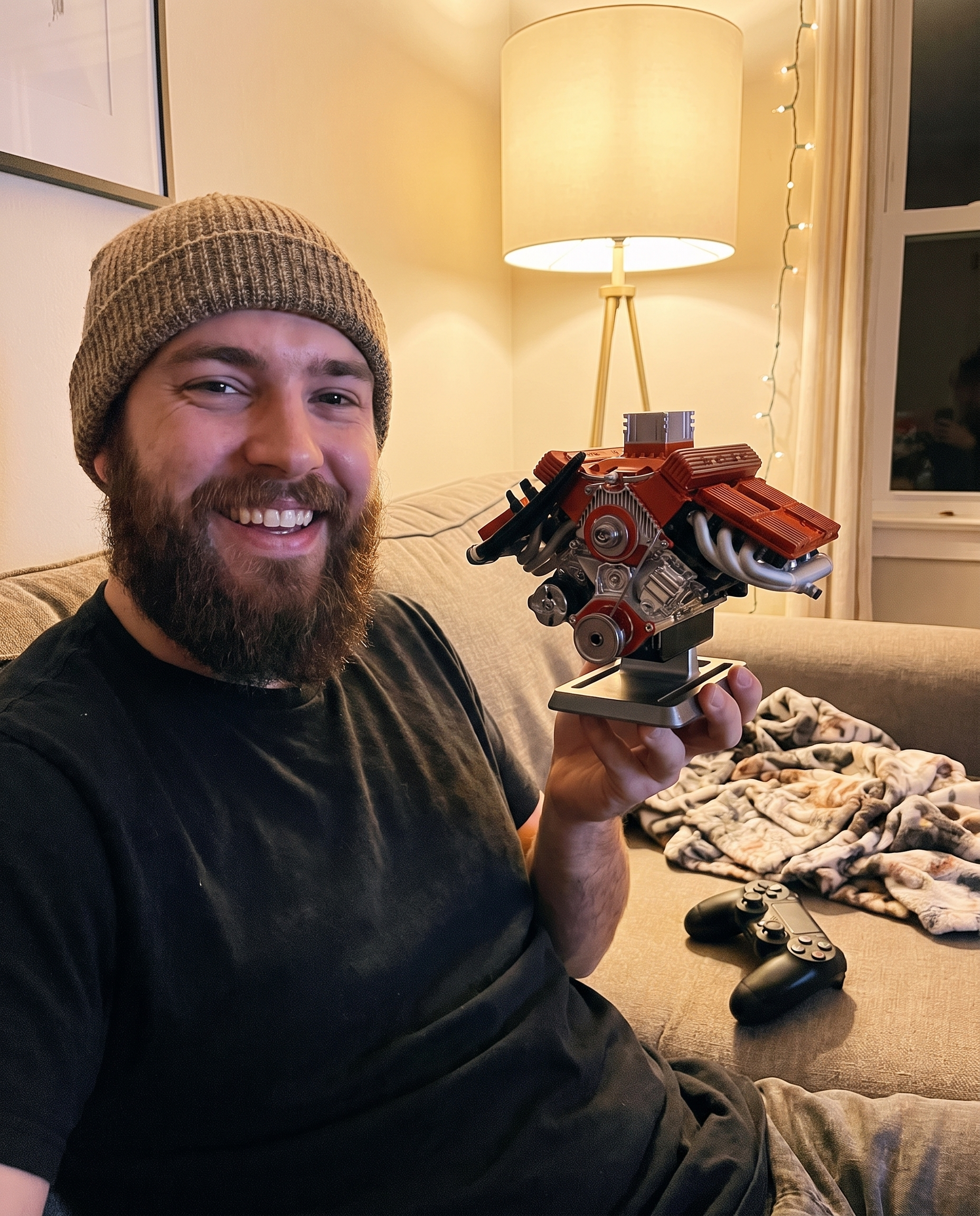 Photo client : un jeune homme sur son canapé tend le moteur PistonPlay vers l'objectif